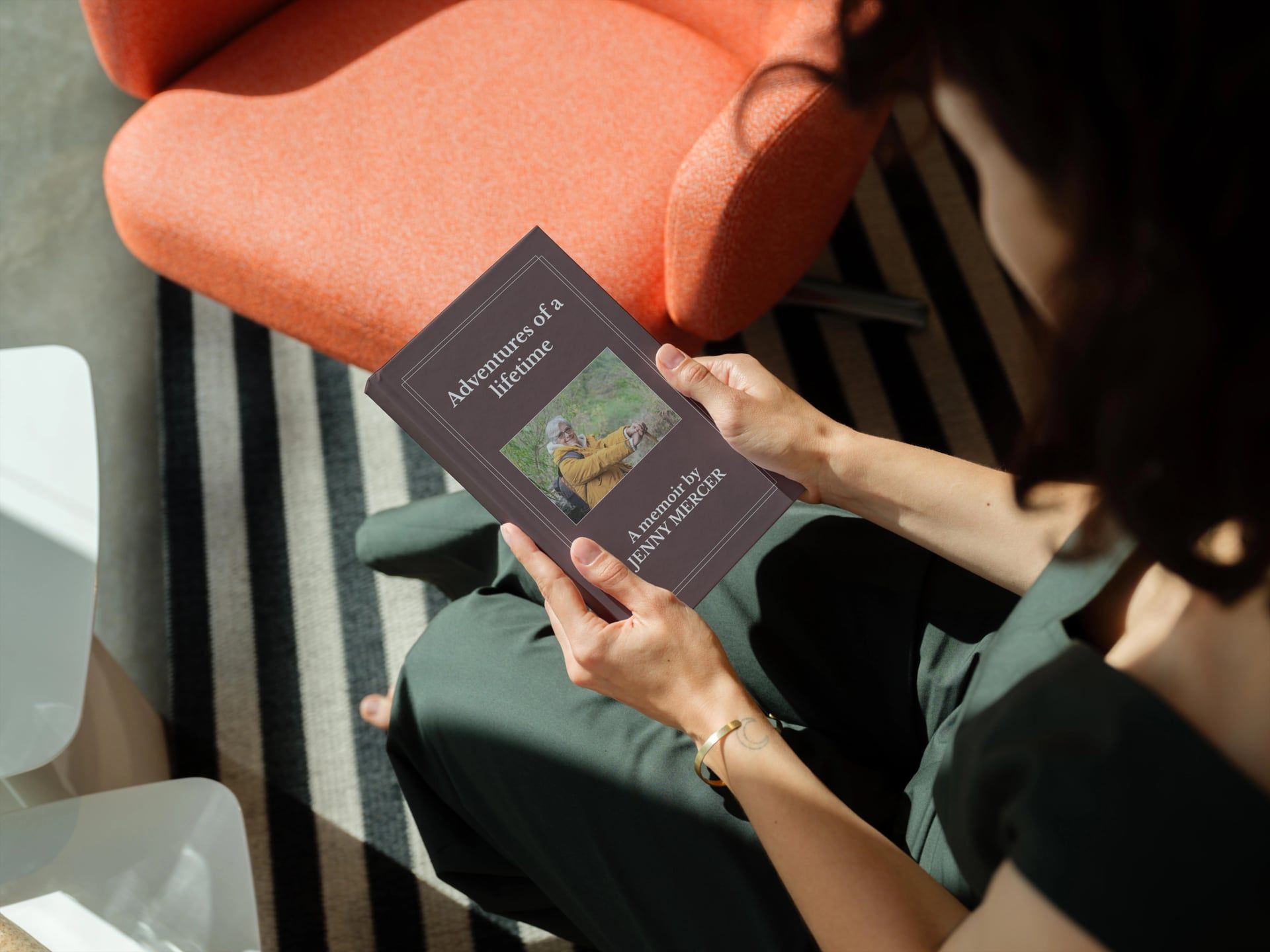 Person reading Adventures of a lifetime family memoir book